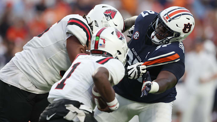 Sep 6, 2025; Auburn, Alabama, USA;  Auburn Tigers defensive lineman Bobby Jamison-Travis (97) reaches for Ball State Cardinals quarterback Kiael Kelly (1) during the first quarter at Jordan-Hare Stadium. Mandatory Credit: John Reed-Imagn Images