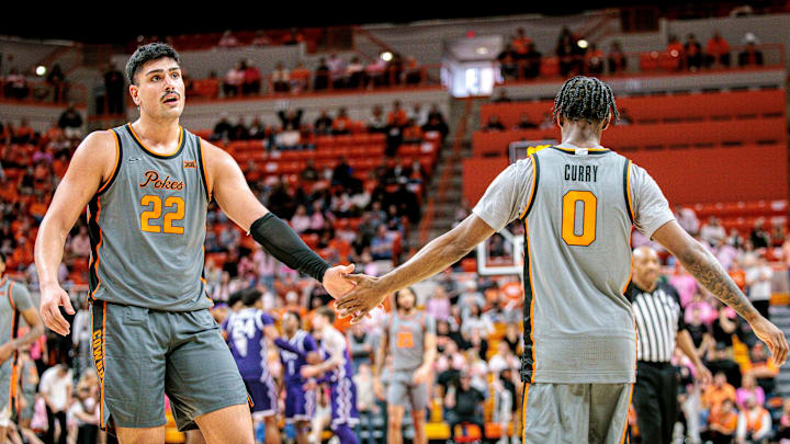 Feb 14, 2026; Stillwater, Oklahoma, USA; Oklahoma State Cowboys forward Parsa Fallah (22) slaps hands with Oklahoma State Cowboys guard Jaylen Curry (0) during the second half against the TCU Horned Frogs at Gallagher-Iba Arena. Mandatory Credit: William Purnell-Imagn Images