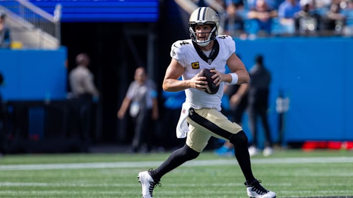 Nov 3, 2024; Charlotte, North Carolina, USA; New Orleans Saints quarterback Derek Carr (4) runs with the ball against the Carolina Panthers during the second quarter of at Bank of America Stadium. Mandatory Credit: Scott Kinser-Imagn Images Nov 3, 2024; Charlotte, North Carolina, USA; New Orleans Saints quarterback Derek Carr (4) runs with the ball against the Carolina Panthers during the second quarter of at Bank of America Stadium. Mandatory Credit: Scott Kinser-Imagn Images