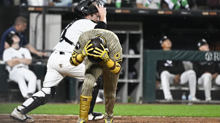 Sep 20, 2025; Chicago, Illinois, USA;  San Diego Padres first base Luis Arraez (4) grabs his helmet after popping up during the sixth inning against the Chicago White Sox at Rate Field. Mandatory Credit: Matt Marton-Imagn Images