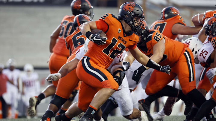 Oct 15, 2022; Corvallis, Oregon, USA; Oregon State Beavers inside linebacker Jack Colletto (12) runs the ball against Washington State Cougars defensive end Quinn Roff (20) during the first half at Reser Stadium. Mandatory Credit: Soobum Im-USA TODAY Sports Oct 15, 2022; Corvallis, Oregon, USA; Oregon State Beavers inside linebacker Jack Colletto (12) runs the ball against Washington State Cougars defensive end Quinn Roff (20) during the first half at Reser Stadium. Mandatory Credit: Soobum Im-USA TODAY Sports