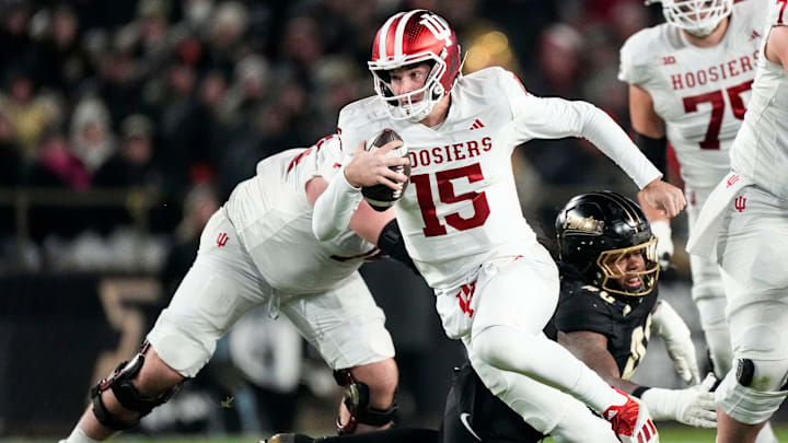 Indiana Hoosiers quarterback Fernando Mendoza (15) rushes up the field Friday, Nov. 28, 2025, during the 100th annual Old Oaken Bucket game at Ross-Ade Stadium in West Lafayette.