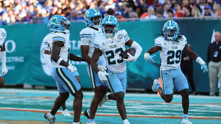 Dec 20, 2024; Tampa, FL, USA; Tulane Green Wave safety Kevin Adams III (23) celebrates after intercepting the ball against the Florida Gators during the first quarter at Raymond James Stadium. 