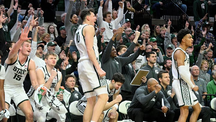 Dec 30, 2024; East Lansing, Michigan, USA;  The Michigan State Spartans bench reacts after a basket late in their game against the Western Michigan Broncos at Jack Breslin Student Events Center. Mandatory Credit: Dale Young-Imagn Images