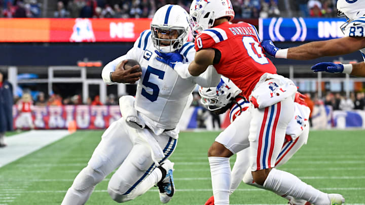 Dec 1, 2024; Foxborough, Massachusetts, USA; New England Patriots cornerback Christian Gonzalez (0) tackles Indianapolis Colts quarterback Anthony Richardson (5) during the second half at Gillette Stadium. Mandatory Credit: Eric Canha-Imagn Images Dec 1, 2024; Foxborough, Massachusetts, USA; New England Patriots cornerback Christian Gonzalez (0) tackles Indianapolis Colts quarterback Anthony Richardson (5) during the second half at Gillette Stadium. Mandatory Credit: Eric Canha-Imagn Images