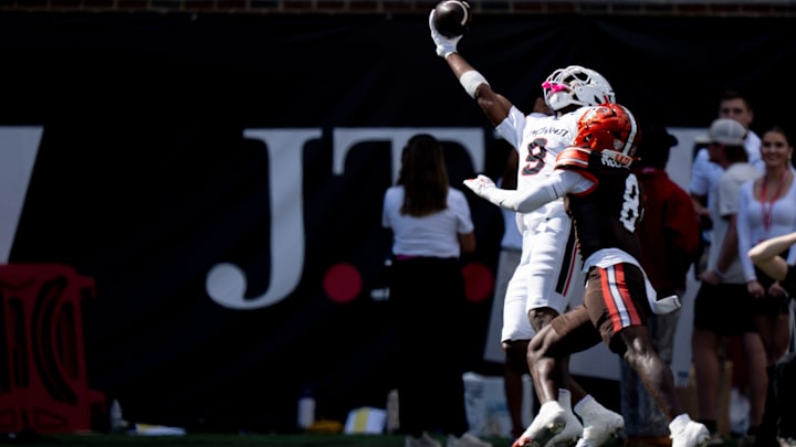 Cincinnati Bearcats wide receiver Jeff Caldwell (9) catches a pass as Bowling Green Falcons cornerback Jalen McClendon (8) defends in the second quarter of the NCAA football game between the Cincinnati Bearcats and Bowling Green Falcons at Nippert Stadium in Cincinnati on Sept. 6, 2025.