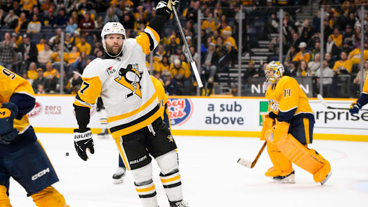Dec 19, 2024; Nashville, Tennessee, USA;  Pittsburgh Penguins right wing Bryan Rust (17) celebrates the game winner against the Nashville Predators during the 1st overtime period at Bridgestone Arena. Mandatory Credit: Steve Roberts-Imagn Images