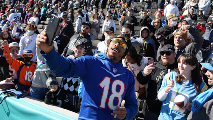 Feb 4, 2022; Las Vegas, NV, USA; Minnesota Vikings wide receiver Justin Jefferson (18) poses for selfie with fans during NFC practice at the Las Vegas Ballpark. Mandatory Credit: Kirby Lee-Imagn Images