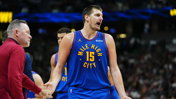 Nov 4, 2023; Denver, Colorado, USA; Denver Nuggets center Nikola Jokic (15) reacts next to head coach Michael Malone in the second half against the Chicago Bulls at Ball Arena. Mandatory Credit: Ron Chenoy-Imagn Images