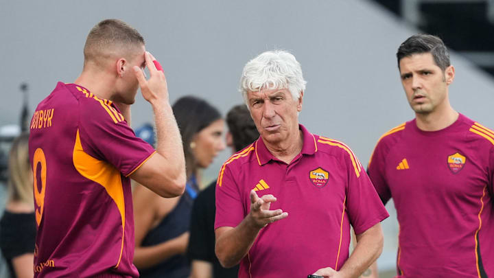 Gian Piero Gasperini, head coach of AS Roma (c), talks with...