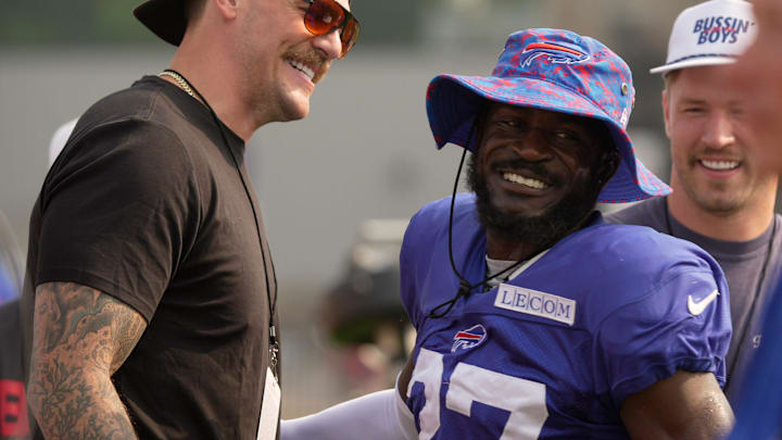 Buffalo Bills cornerback Tre'Davious White comes over to Taylor Lewan and Will Compton, behind him, to say hello before Bills Training Camp at St. John Fisher University in Pittsford on Aug.6, 2025. Lewan and Compton, former NFL players, have a podcast “Bussin with the Boys, and were going to interview Brandon Beane and Josh Allen, after practice.