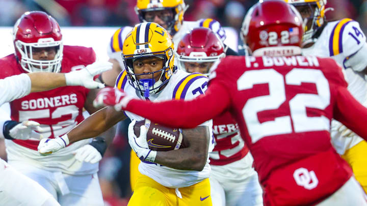 Louisiana State Tigers running back Harlem Berry (22) runs with the ball as Oklahoma Sooners defensive back Peyton Bowen (22) defends during the second half at Gaylord Family-Oklahoma Memorial Stadium.