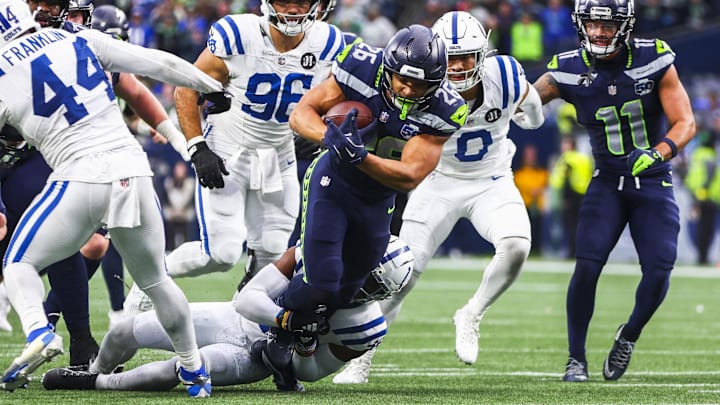 Dec 14, 2025; Seattle, Washington, USA; Seattle Seahawks running back Zach Charbonnet (26) rushes against the Indianapolis Colts during the second half at Lumen Field. Mandatory Credit: Kevin Ng-Imagn Images