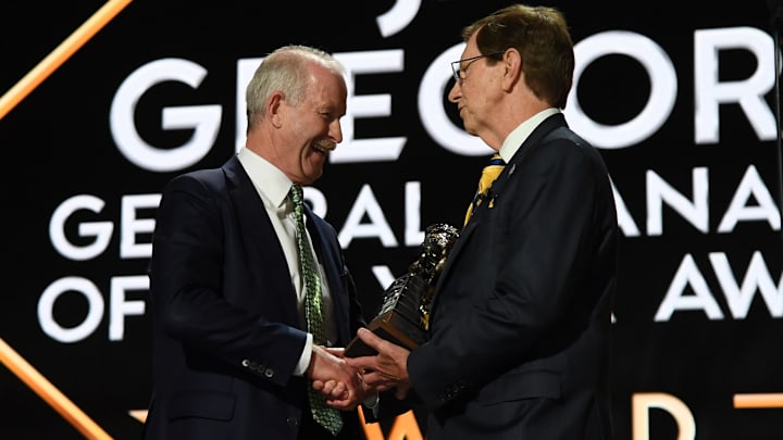 Jun 28, 2023; Nashville, Tennessee, USA; Dallas Stars general manager Jim Nill is awarded the Jim Gregory General Manager of the Year award by Nashville Predators general manager David Poile during the first round of the 2023 NHL Draft at Bridgestone Arena. Mandatory Credit: Christopher Hanewinckel-Imagn Images