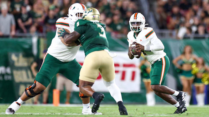 Sep 21, 2024; Tampa, Florida, USA; Miami Hurricanes quarterback Cam Ward (1) drops back to pass against the South Florida Bulls in the second quarter at Raymond James Stadium. Mandatory Credit: Nathan Ray Seebeck-Imagn Images