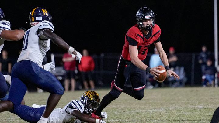 Naples Golden Eagles defensive back Tariq Arbyummi (3) dives and sacks Port Charlotte Pirates quarterback Logan Flaherty (17) during the fourth quarter of the Class 4A Region 3 championship at Port Charlotte High School in Port Charlotte, Fla., on Friday, Nov. 29, 2024. Naples Golden Eagles defensive back Tariq Arbyummi (3) dives and sacks Port Charlotte Pirates quarterback Logan Flaherty (17) during the fourth quarter of the Class 4A Region 3 championship at Port Charlotte High School in Port Charlotte, Fla., on Friday, Nov. 29, 2024.