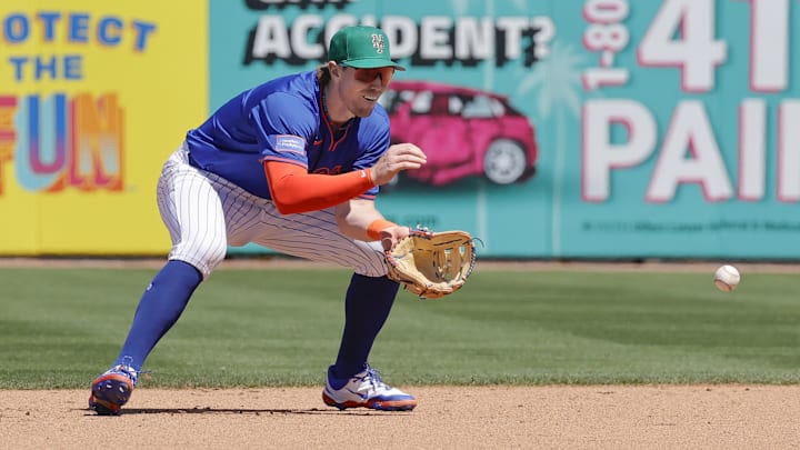 Mar 17, 2025; Port St. Lucie, Florida, USA;  New York Mets third base Brett Baty (7) fields a ground ball during the fifth inning against the Tampa Bay Rays at Clover Park. Mandatory Credit: Reinhold Matay-Imagn Images 