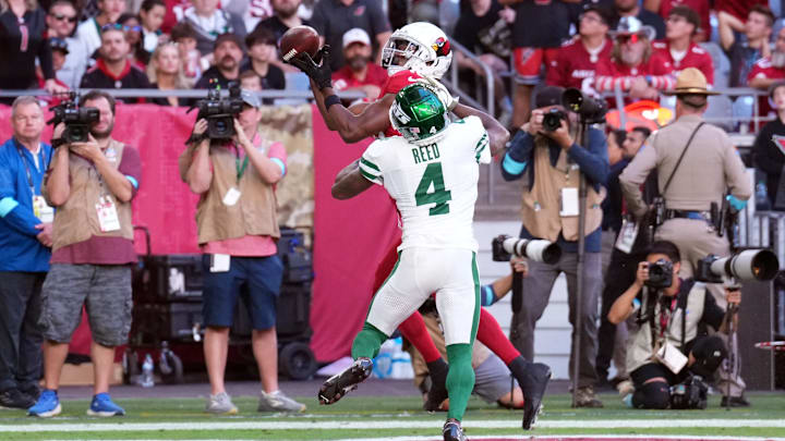 Nov 10, 2024; Glendale, Arizona, USA; Arizona Cardinals wide receiver Marvin Harrison Jr. (18) catches a touchdown pas against New York Jets cornerback D.J. Reed (4) during the first half at State Farm Stadium. Mandatory Credit: Joe Camporeale-Imagn Images Nov 10, 2024; Glendale, Arizona, USA; Arizona Cardinals wide receiver Marvin Harrison Jr. (18) catches a touchdown pas against New York Jets cornerback D.J. Reed (4) during the first half at State Farm Stadium. Mandatory Credit: Joe Camporeale-Imagn Images