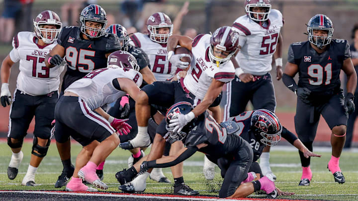 Jenks’ Kaydin Jones (2) runs the ball during a high school football game between Mustang and Jenks in Mustang, Okla., on Friday, Oct. 11, 2024.