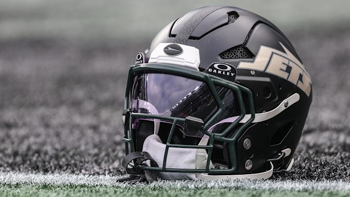 Dec 7, 2025; East Rutherford, New Jersey, USA; A general view of a Gotham City football rivalries helmet resting on the field before the game against the Miami Dolphins at MetLife Stadium. Mandatory Credit: Vincent Carchietta-Imagn Images