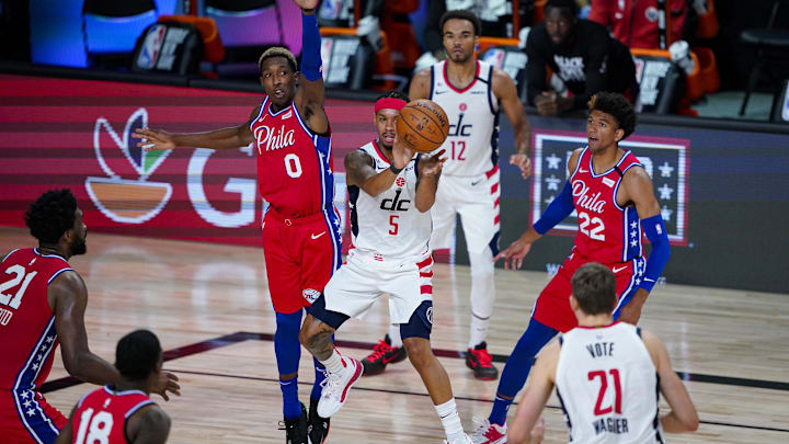 Aug 5, 2020; Lake Buena Vista, Florida, USA; Washington Wizards guard Shabazz Napier (5) makes a pass in front of Philadelphia 76ers guard Josh Richardson (0) during the second half of an NBA basketball game Wednesday, Aug. 5, 2020 in Lake Buena Vista, Fla. Mandatory Credit: Ashley Landis/Pool Photo-Imagn Images
