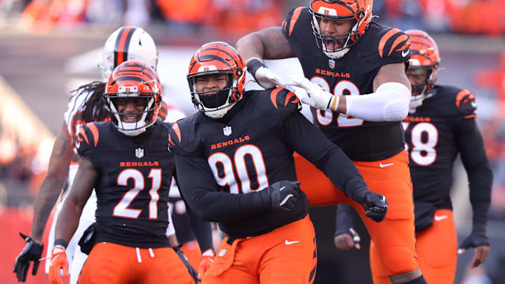 Dec 22, 2024; Cincinnati, Ohio, USA;  Cincinnati Bengals defensive tackle B.J. Hill (92) celebrates a sack with defensive tackle Kris Jenkins Jr. (90) during the first quarter against the Cleveland Browns at Paycor Stadium. Mandatory Credit: Joseph Maiorana-Imagn Images