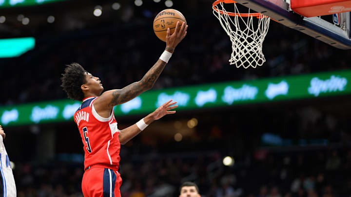 Mar 21, 2025; Washington, District of Columbia, USA; Washington Wizards guard AJ Johnson (5) drives to the basket during the fourth quarter against the Orlando Magic at Capital One Arena. Mandatory Credit: Reggie Hildred-Imagn Images