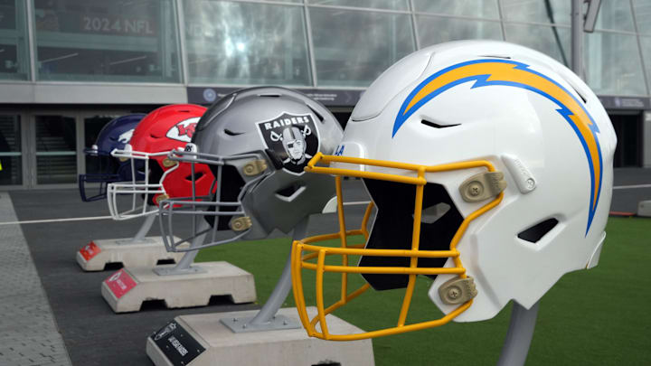 Oct 13, 2024; London, United Kingdom; Large helmets of the Los Angeles Chargers, Las Vegas Raiders, Kansas City Chiefs and Denver Broncos of the AFC West before an NFL International Series game at Tottenham Hotspur Stadium. Mandatory Credit: Kirby Lee-Imagn Images
