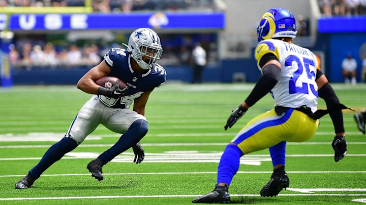 Dallas Cowboys running back Malik Davis runs the ball against Los Angeles Rams safety Jason Taylor II during the 2024 NFL preseason Dallas Cowboys running back Malik Davis runs the ball against Los Angeles Rams safety Jason Taylor II during the 2024 NFL preseason