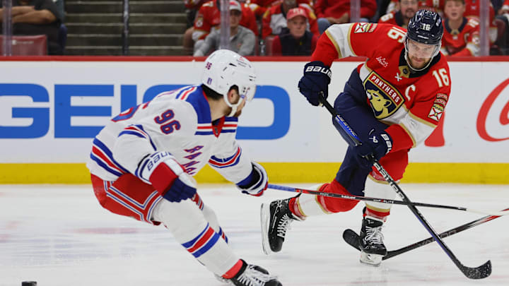 May 26, 2024; Sunrise, Florida, USA; Florida Panthers center Aleksander Barkov (16) moves the puck as New York Rangers center Jack Roslovic (96) defends during the third period in game three of the Eastern Conference Final of the 2024 Stanley Cup Playoffs at Amerant Bank Arena. Mandatory Credit: Sam Navarro-USA TODAY Sports
