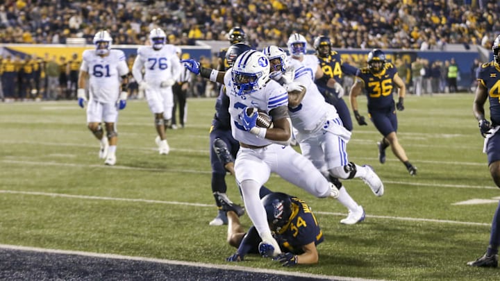 Nov 4, 2023; Morgantown, West Virginia, USA; Brigham Young Cougars running back Aidan Robbins (3) runs in for a touchdown during the fourth quarter against the West Virginia Mountaineers at Mountaineer Field at Milan Puskar Stadium. Mandatory Credit: Ben Queen-Imagn Images
