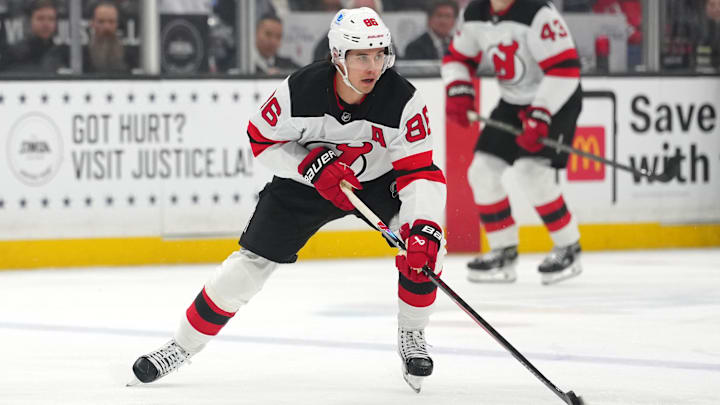 Nov 1, 2025; Los Angeles, California, USA; New Jersey Devils center Jack Hughes (86) skates with the puck against the Los Angeles Kings in the first period at Crypto.com Arena. Mandatory Credit: Kirby Lee-Imagn Images