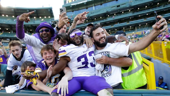 Minnesota Vikings running back Aaron Jones (33) does a Lambeau Leap with fans following a 31-29 victory against the Green Bay Packers Sunday, September 29, 2024, at Lambeau Field in Green Bay, Wisconsin. Minnesota Vikings running back Aaron Jones (33) does a Lambeau Leap with fans following a 31-29 victory against the Green Bay Packers Sunday, September 29, 2024, at Lambeau Field in Green Bay, Wisconsin.