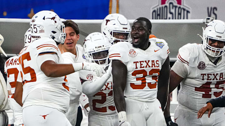 Texas Longhorns linebacker David Gbenda (33) celebrates an interception during the College Football Playoff semifinal game against Ohio State in the Cotton Bowl at AT&T Stadium on Friday, Jan. 10, 2024 in Arlington, Texas.