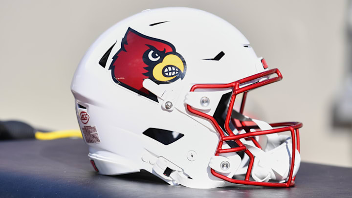 Nov 1, 2025; Blacksburg, Virginia, USA; A Louisville Cardinals football helmet is seen before the game against the Virginia Tech Hokies at Lane Stadium. Mandatory Credit: Brian Bishop-Imagn Images Nov 1, 2025; Blacksburg, Virginia, USA; A Louisville Cardinals football helmet is seen before the game against the Virginia Tech Hokies at Lane Stadium. Mandatory Credit: Brian Bishop-Imagn Images