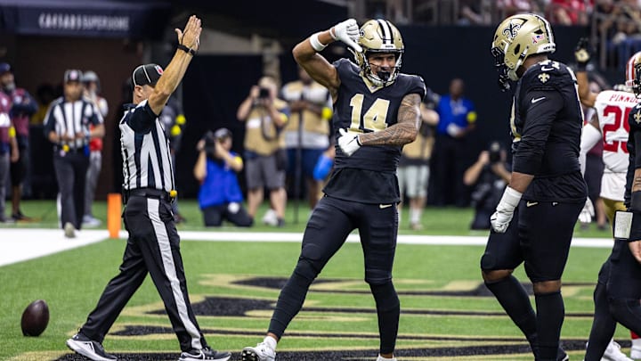 Sep 14, 2025; New Orleans, Louisiana, USA;  New Orleans Saints wide receiver Devaughn Vele (14) reacts to scoring a touchdown against San Francisco 49ers safety Jason Pinnock (25) during the second half at Caesars Superdome. Mandatory Credit: Stephen Lew-Imagn Images