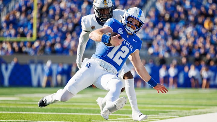 Nov 16, 2024; Lexington, Kentucky, USA; Kentucky Wildcats quarterback Brock Vandagriff (12) is forced out of bounds by Murray State Racers linebacker Justice Cross (7) during the second quarter at Kroger Field. Mandatory Credit: Jordan Prather-Imagn Images