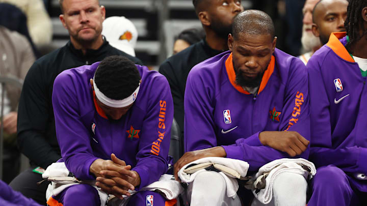 Dec 19, 2024; Phoenix, Arizona, USA; Phoenix Suns guard Bradley Beal (left) and forward Kevin Durant react on the bench against the Indiana Pacers at Footprint Center. Mandatory Credit: Mark J. Rebilas-Imagn Images