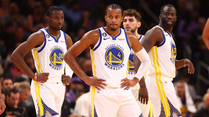 Golden State Warriors guard Moses Moody (4), forward Jonathan Kuminga (00) and forward Draymond Green (23) against the Phoenix Suns at Footprint Center. Mandatory Credit: Mark J. Rebilas-Imagn Images