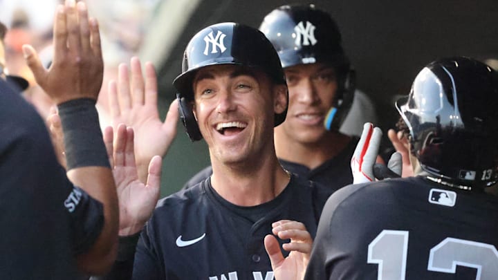 Mar 20, 2025; Sarasota, Florida, USA;  New York Yankees outfielder Cody Bellinger (35), New York Yankees third base Jazz Chisholm Jr. (13) and New York Yankees outfielder Aaron Judge (99) high five after scoring during the third inning against the Baltimore Orioles at Ed Smith Stadium. 