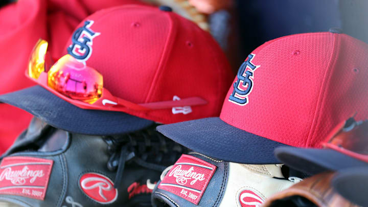 Mar 6, 2019; Tampa, FL, USA; St. Louis Cardinals hat and gloves lay in the dugout at George M. Steinbrenner Field. Mandatory Credit: Kim Klement-Imagn Images