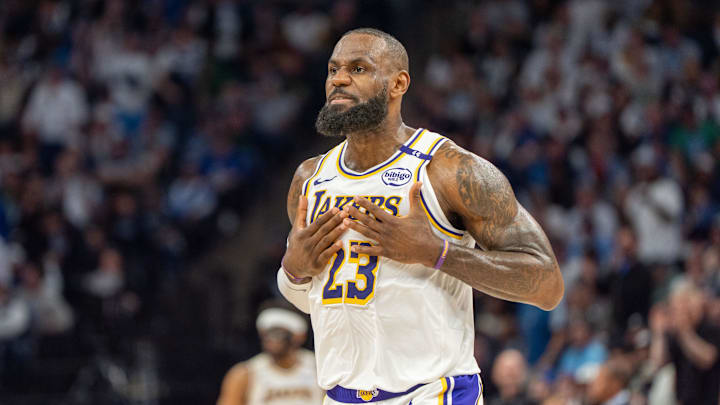 Los Angeles Lakers forward LeBron James (23) talks with his coach during a stoppage in play against the Minnesota Timberwolves in the second quarter during game four of first round for the 2025 NBA Playoffs at Target Center. 