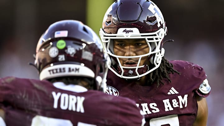 Sep 27, 2025; College Station, Texas, USA; Texas A&M Aggies defensive end T.J. Searcy (18) congratulates linebacker Taurean York (21) after a sack in the second half against the Auburn Tigers at Kyle Field. Mandatory Credit: Maria Lysaker-Imagn Images 
