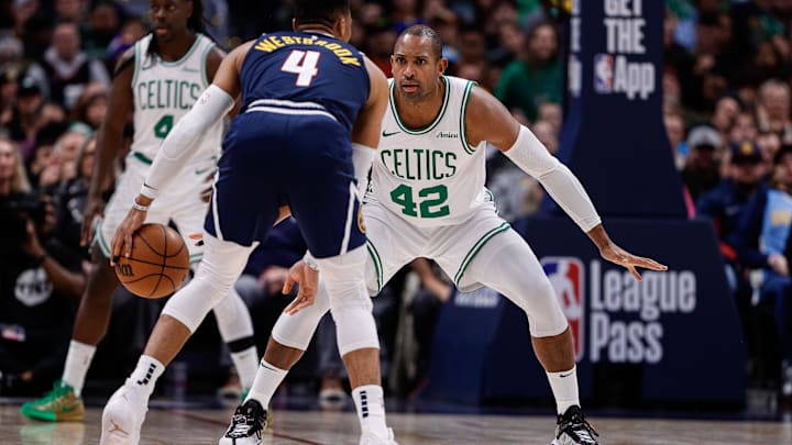 Jan 7, 2025; Denver, Colorado, USA; Denver Nuggets guard Russell Westbrook (4) controls the ball as Boston Celtics center Al Horford (42) guards in the third quarter at Ball Arena. Mandatory Credit: Isaiah J. Downing-Imagn Images