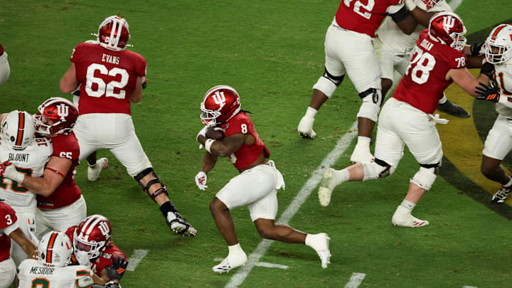 Jan 19, 2026; Miami Gardens, FL, USA; Indiana Hoosiers running back Kaelon Black (8) carries the ball against the Miami Hurricanes in the second quarter during the College Football Playoff National Championship game at Hard Rock Stadium. Mandatory Credit: Kim Klement Neitzel-Imagn Images