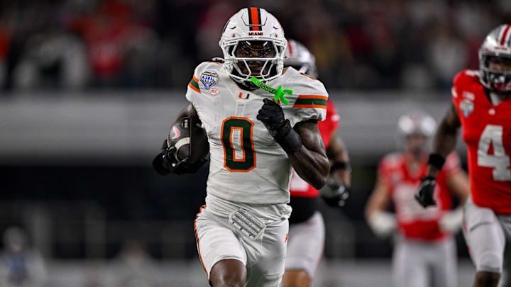 Miami Hurricanes defensive back Keionte Scott (0) returns an interception for a touchdown during the 2025 Cotton Bowl and quarterfinal game of the College Football Playoff at AT&T Stadium. Mandatory Credit: Jerome Miron-Imagn Images