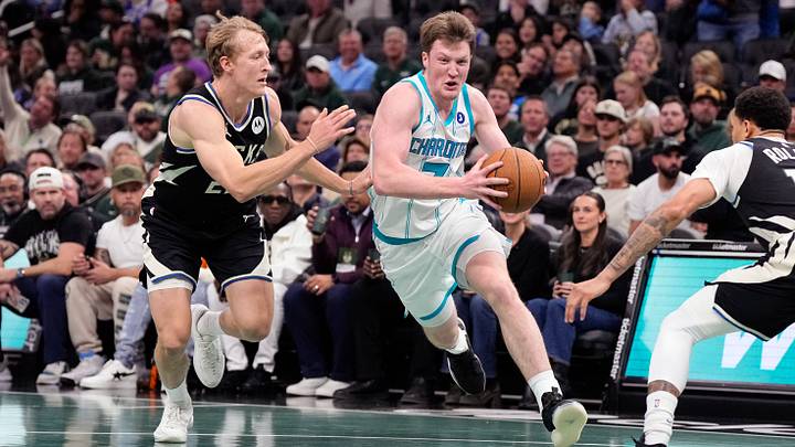 Nov 14, 2025; Milwaukee, Wisconsin, USA;  Charlotte Hornets guard Kon Knueppel (7) drives towards the basket against Milwaukee Bucks guard AJ Green (20) during the first quarter at Fiserv Forum. Mandatory Credit: Jeff Hanisch-Imagn Images