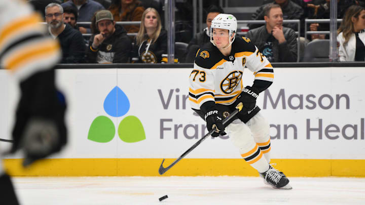 Dec 12, 2024; Seattle, Washington, USA; Boston Bruins defenseman Charlie McAvoy (73) plays the puck during the third period against the Seattle Kraken at Climate Pledge Arena. Mandatory Credit: Steven Bisig-Imagn Images