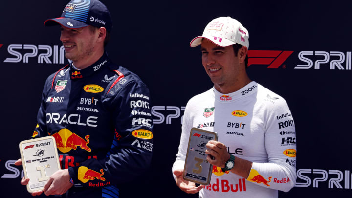 May 4, 2024; Miami Gardens, Florida, USA; Red Bull Racing driver Max Verstappen (1) poses with first place trophy and Red Bull Racing driver Sergio Perez (11) poses with the third place trophy the after winning the F1 Sprint Race at Miami International Autodrome. Mandatory Credit: Peter Casey-USA TODAY Sports