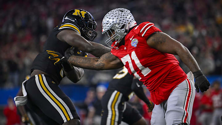 Dec 29, 2023; Arlington, TX, USA; Ohio State Buckeyes offensive lineman Josh Simmons (71) blocks Missouri Tigers defensive lineman Darius Robinson (6) during the second quarter at AT&T Stadium. Mandatory Credit: Jerome Miron-Imagn Images